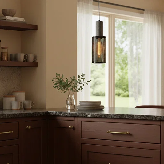Twin gold metal pendant lights enhancing kitchen decor with minimalist elegance and soft illumination.