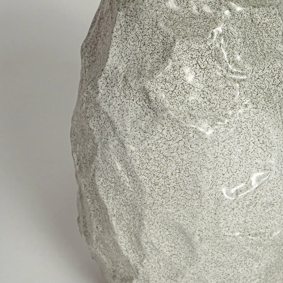 White decorative textured ceramic vase on white background modern home decor accent piece for table shelf console styling.