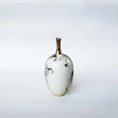 White ceramic decorative vase with grey marble pattern and gold neck for elegant shelf styling and modern home decor.