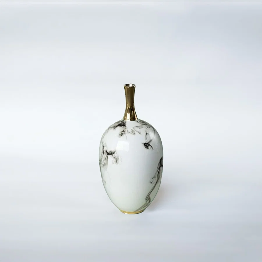 White ceramic decorative vase with grey marble pattern and gold neck for elegant shelf styling and modern home decor.