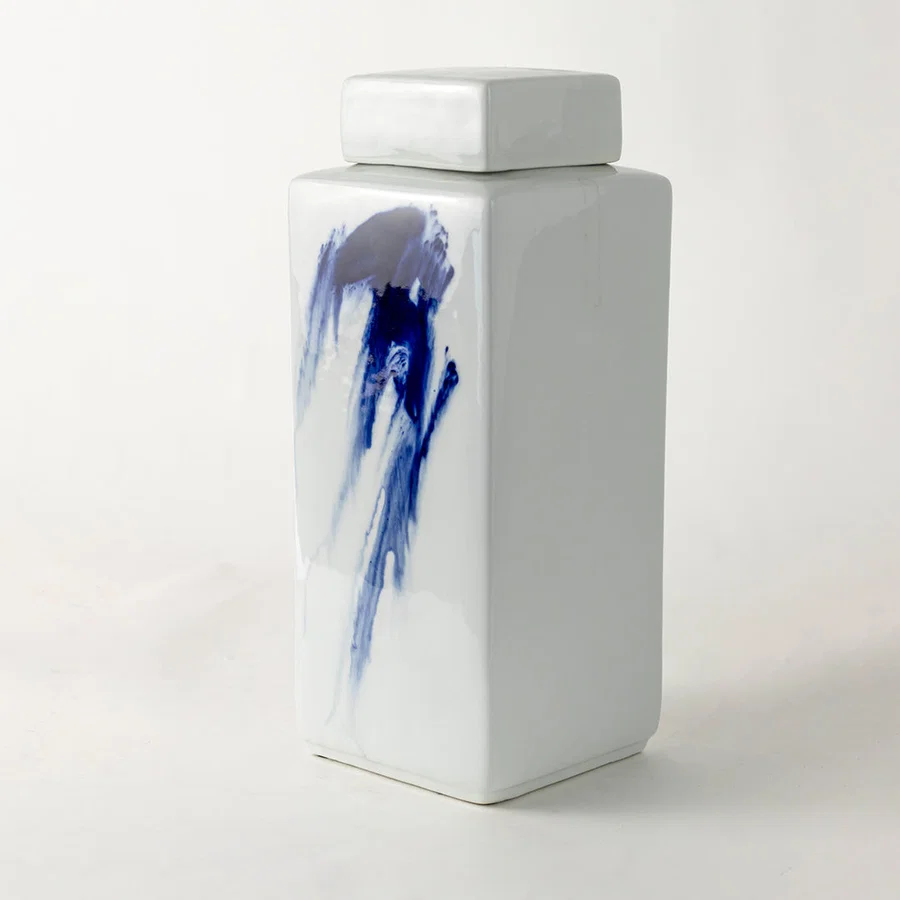 White ceramic decorative jar with blue koi artwork for elegant shelf styling and modern home decor displays.