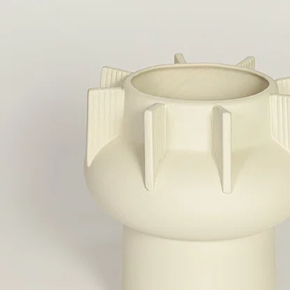 Close view of beige textured ceramic vase with ribbed sculptural details highlighting matte finish for table or shelf placement.