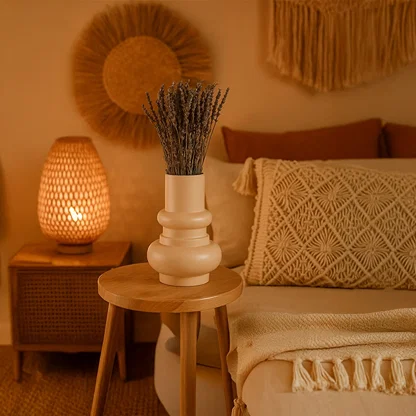 Peach ceramic vase styled on a minimal pedestal with soft lighting  showcasing its bold rounded shape and modern sculptural design.