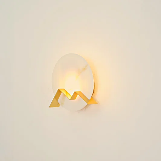 Apex Alabaster Wall Sconce illuminated on white background.