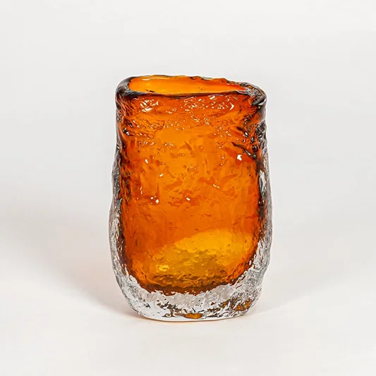 Amber decorative art glass vase on white background modern home decor accent piece for table shelf console styling interior.