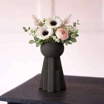 Black ceramic sculptural decorative vase with modern geometric base perfect for dried flower display on console table and stylish home decor.