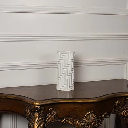 A white geometric pattern vase presented on a clean white background highlighting its tall elegant shape and modern carved texture.