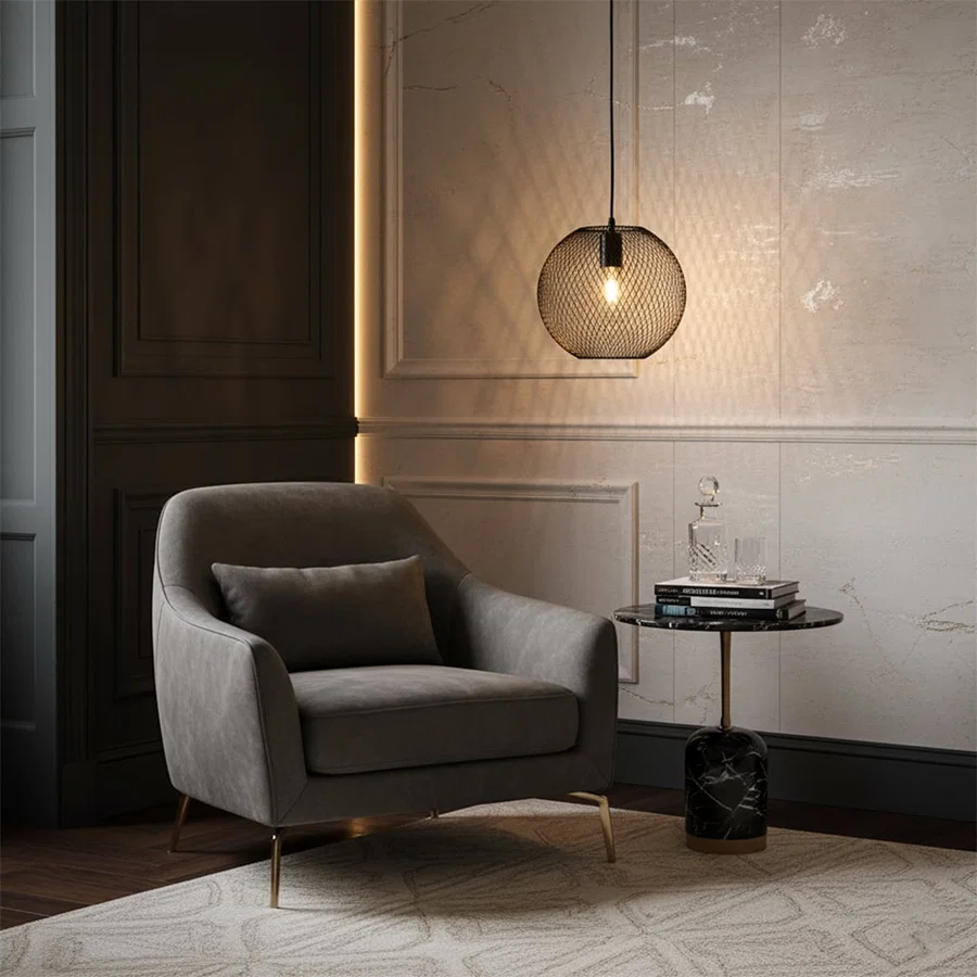 Gold metal pendant light with frosted glass globe shade creating warm ambient lighting beside modern lounge seating.