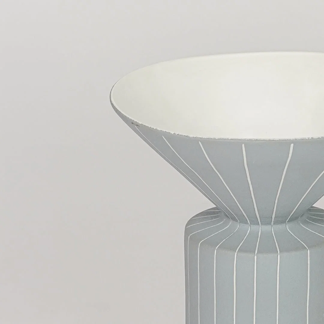 Blue ceramic flower vase closeup with ribbed texture modern decorative vase for shelf console table home decor styling.