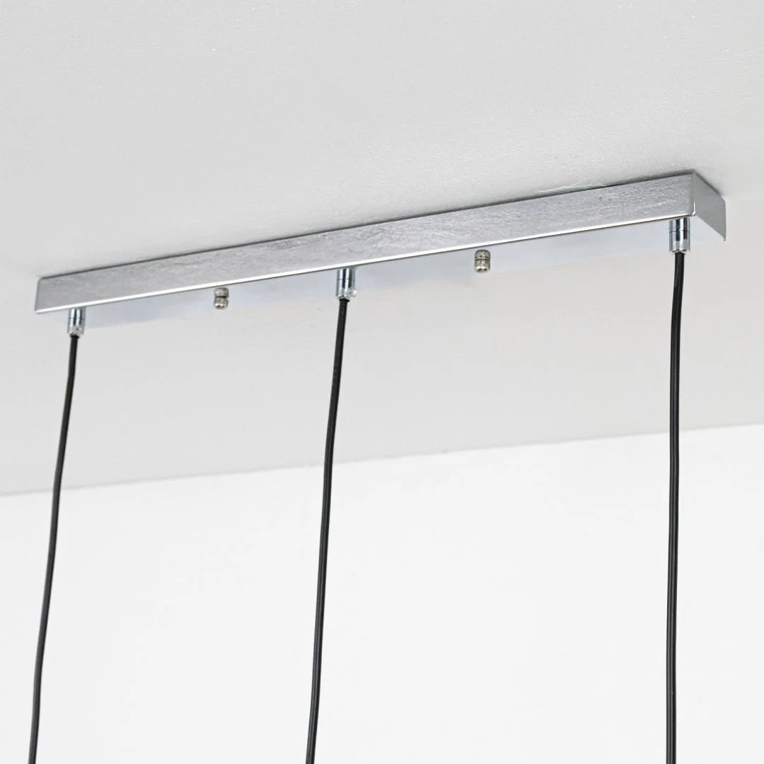 Silver metal linear ceiling canopy with hanging cords highlighting premium finish and craftsmanship.