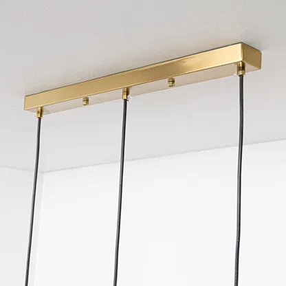 Gold metal linear ceiling canopy with suspended cords showcasing sleek modern craftsmanship and finish.