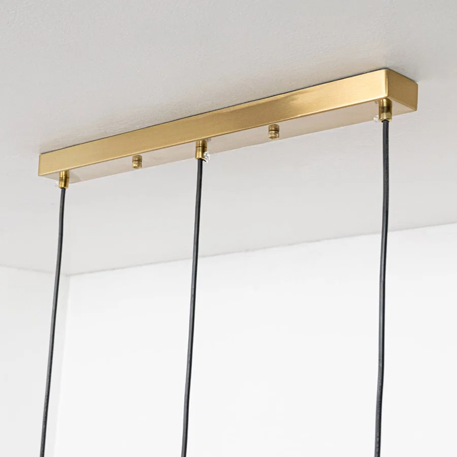 Gold metal linear ceiling canopy with suspended cords showcasing sleek modern craftsmanship and finish.
