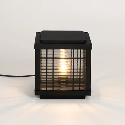 Black outdoor gate light with warm glowing bulb for elegant modern exterior decor styling use.