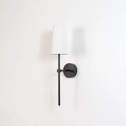 Contemporary white drum shade wall light fixture with tall black metal rod turned off on minimalist white background display.