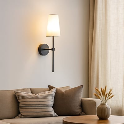 Elegant white fabric drum shade wall sconce with tall black metal rod mounted on interior wall creating refined ambient lighting.