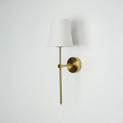 Minimal wall light in gold metal finish with fabric shade for bedroom or living room decor lighting white background.