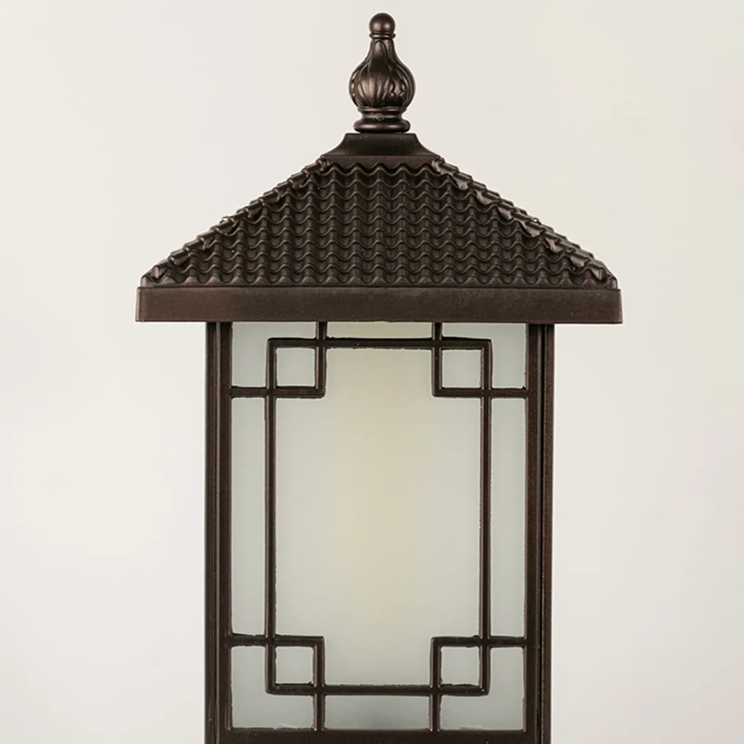 Black outdoor lantern Closeup seeded glass Light On showing the warm ambient glow and decorative pebbled glass panels detail.
