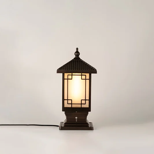 Vintage black outdoor gate light with warm ambient glow for luxury exterior decor styling use.