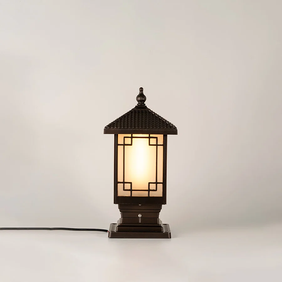 Vintage black outdoor gate light with warm ambient glow for luxury exterior decor styling use.