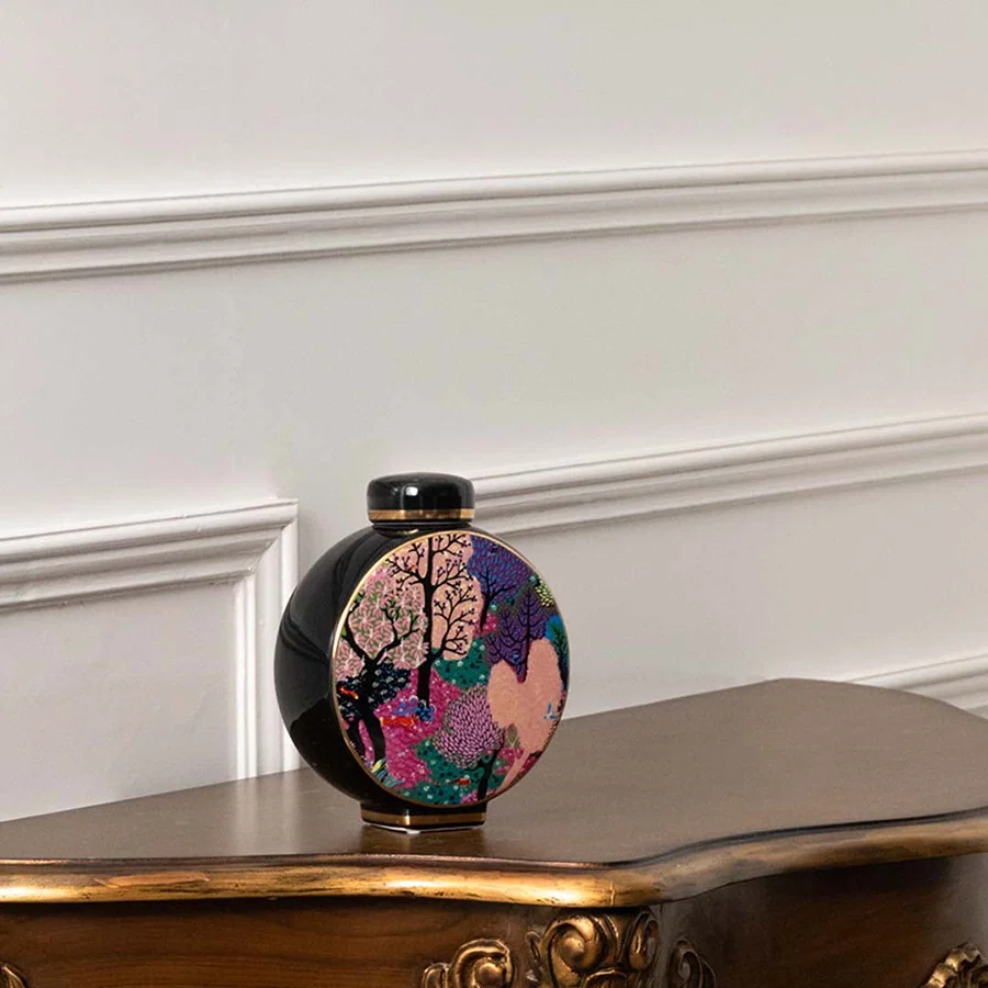Round ceramic decorative jar with artistic tree design displayed on a console table for modern tabletop home decor.