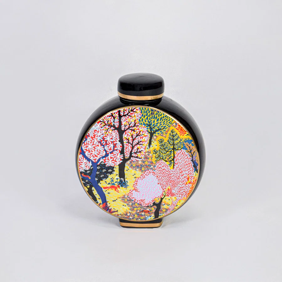 Round ceramic decorative jar with colorful tree design for elegant tabletop styling and luxury home decor displays.