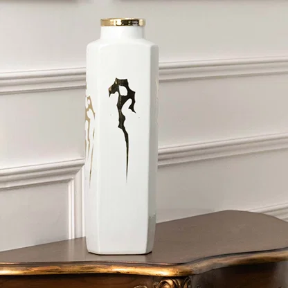 White ceramic decorative vase with black seahorse artwork displayed on a console table for modern home decor styling.
