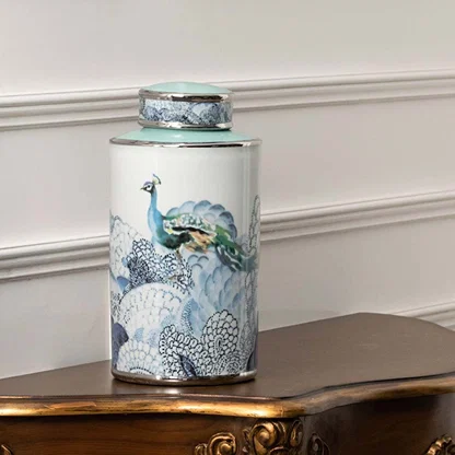 White ceramic decorative jar with blue ocean artwork displayed on a console table for luxury home decor styling.