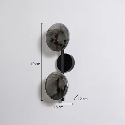Modern black metal wall sconce with dual smoked glass globes showing 40cm height 15cm width 12cm depth on white background.