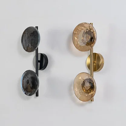 Collection of contemporary black metal dual globe wall lights with smoked glass shades displayed off on white backdrop.
