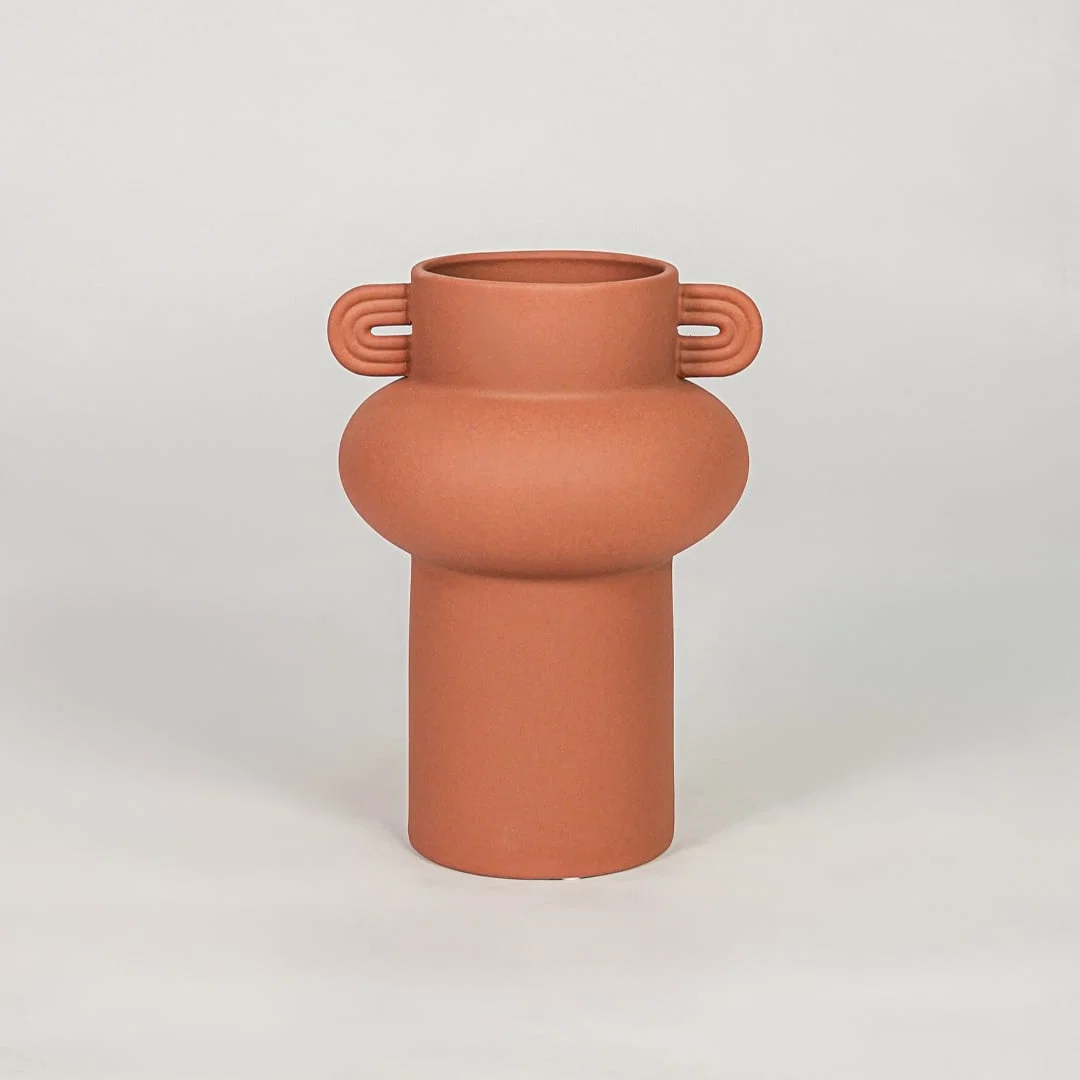 Orange ceramic decorative flower vase with matte finish modern vase for tabletop shelf console living room home decor styling.