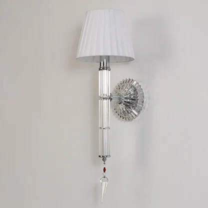 Wall light with chrome base fabric shade and crystal accents turned off on white background for decor.