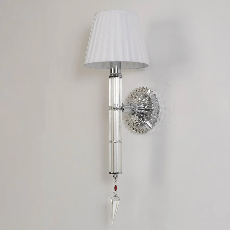 Wall light with chrome base fabric shade and crystal accents turned off on white background for decor.