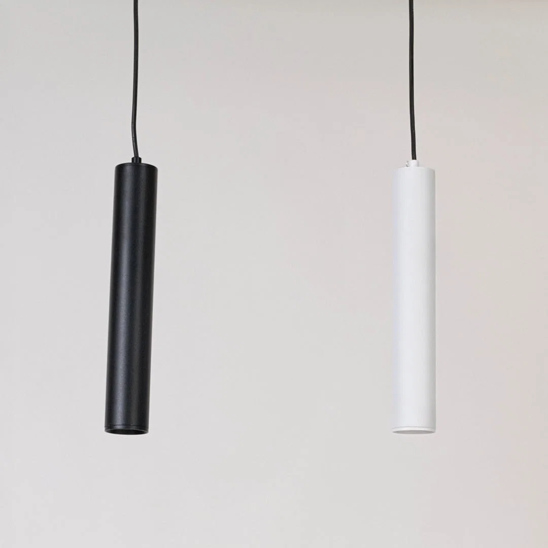 Pair of black and white metal pendant lights designed for elegant bedroom and dining room decor.