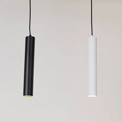 Black and white metal cylindrical pendant lights showcasing sleek minimalist designs for modern interiors.