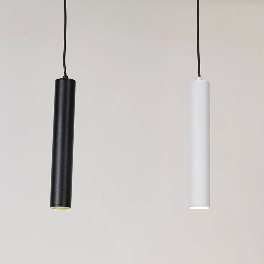 Black and white metal cylindrical pendant lights showcasing sleek minimalist designs for modern interiors.