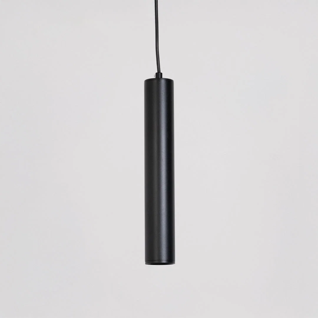 Modern pendant light in black finish with cylindrical design for kitchen island or dining decor lighting white background.