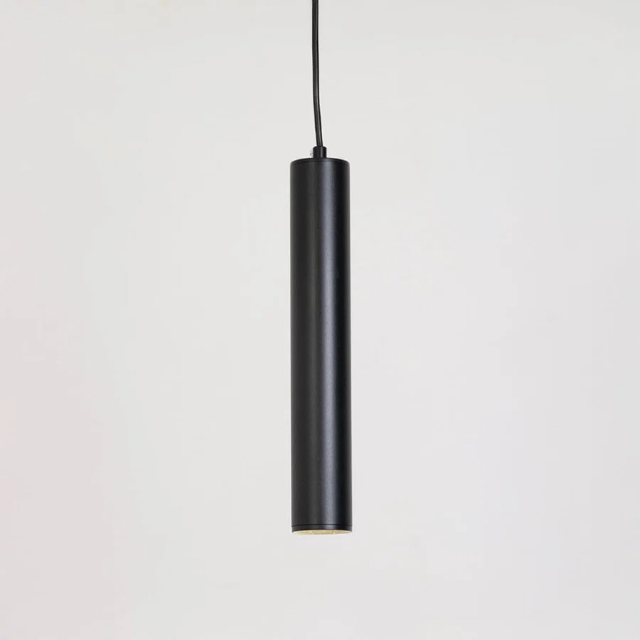 Black metal cylindrical pendant light with minimalist styling for contemporary home decor spaces.