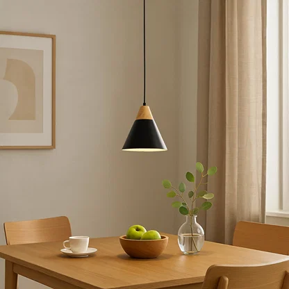 Black metal pendant light above dining table adding Scandinavian elegance and warm ambient lighting to modern interiors.
