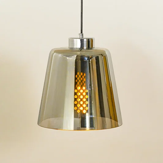 Closeup of chrome metal pendant light with reflective finish for dining room kitchen island and modern interior lighting.
