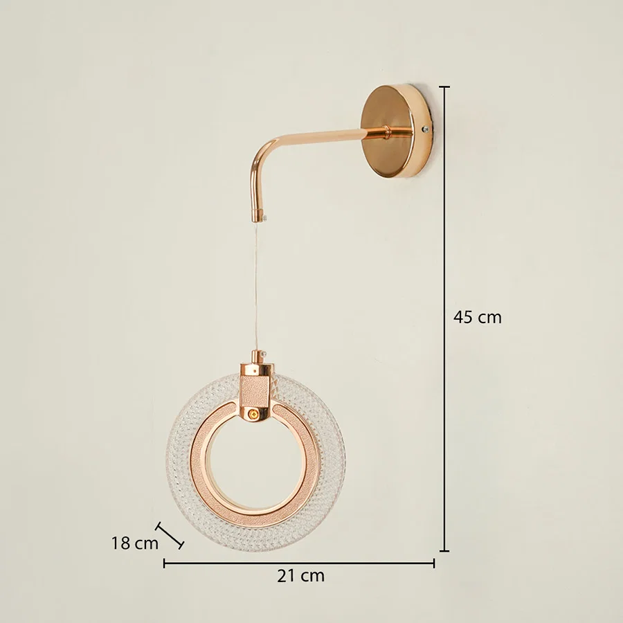 Modern gold wall light measuring 45 cm height 21 cm width and 18 cm depth on white background.