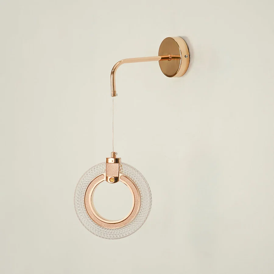 Modern rose gold metal led ring wall sconce pendant hanging light fixture displayed on clean white background image.