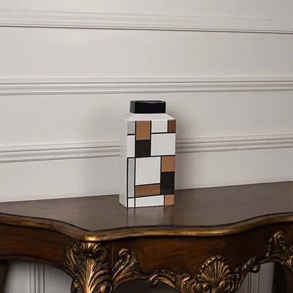 Geometric ceramic vase displayed on a white background featuring a structured modern block pattern.
