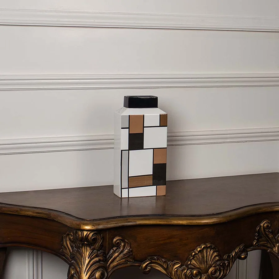 Geometric ceramic vase displayed on a white background featuring a structured modern block pattern.