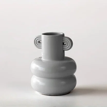 White ceramic sculptural vase with rounded stacked design for tabletop styling and modern home decor displays.