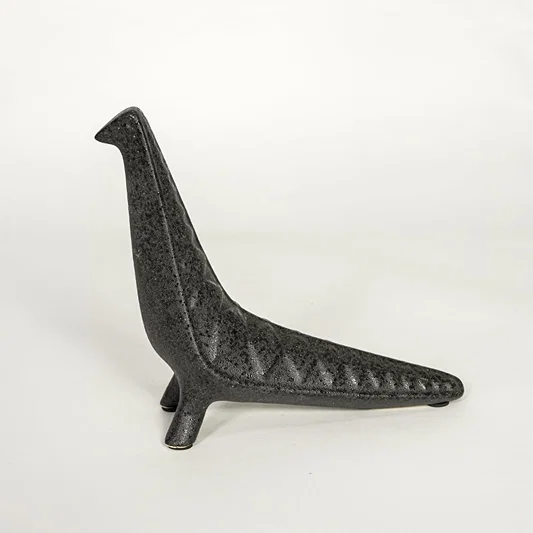 Modern dark grey ceramic decorative animal figurine with elongated body isolated on white background.