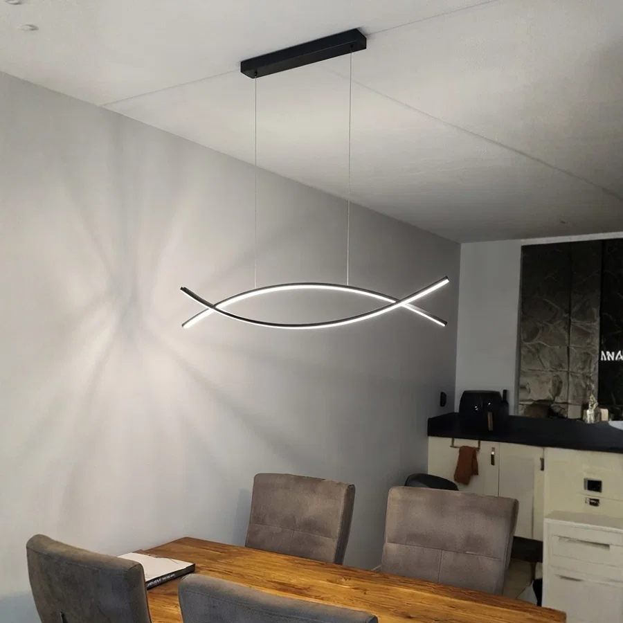 Lifestyle image of dual curve metal linear light for elegant dining room decor styling and modern home interior design.