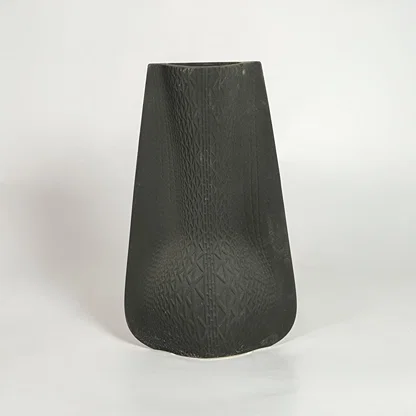Black decorative ceramic vase on white background modern home decor accent piece for table floor console styling interior.