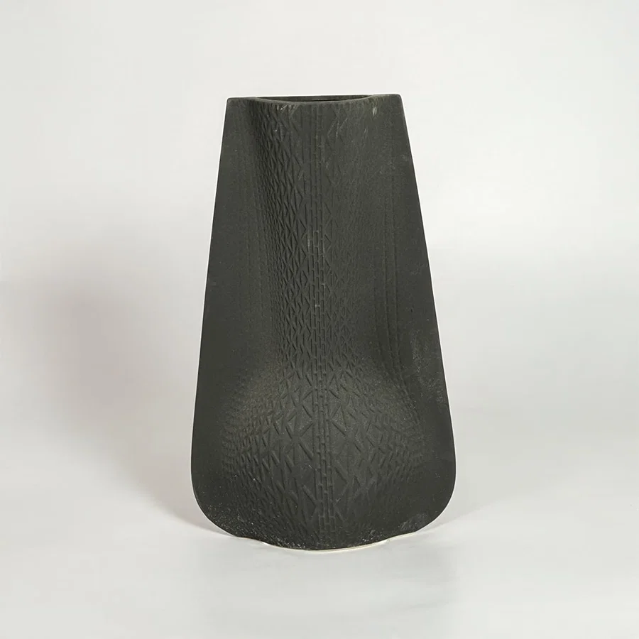 Black decorative ceramic vase on white background modern home decor accent piece for table floor console styling interior.