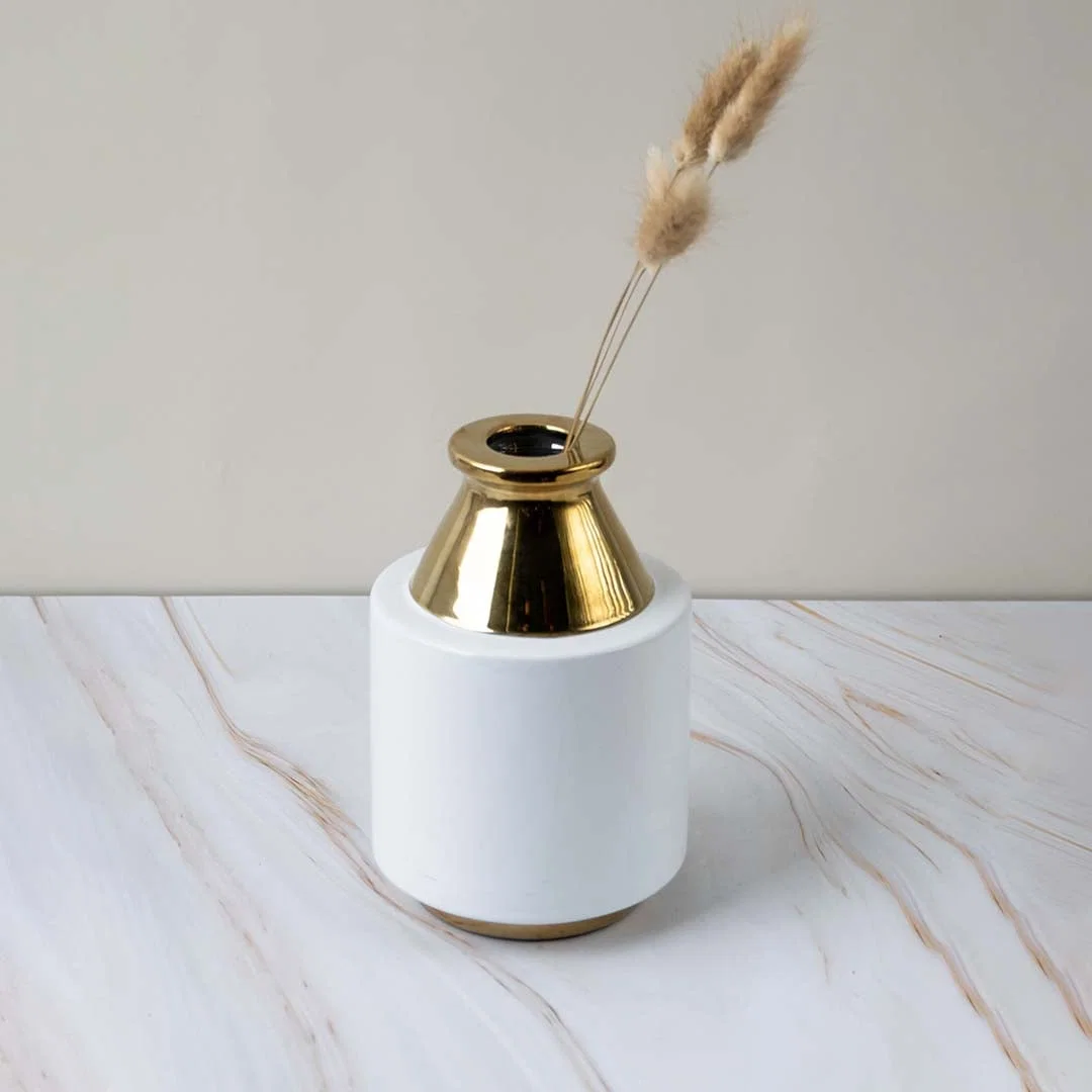 Contemporary white and gold ceramic vase displayed in a minimal lifestyle setup perfect for enhancing stylish home interiors.