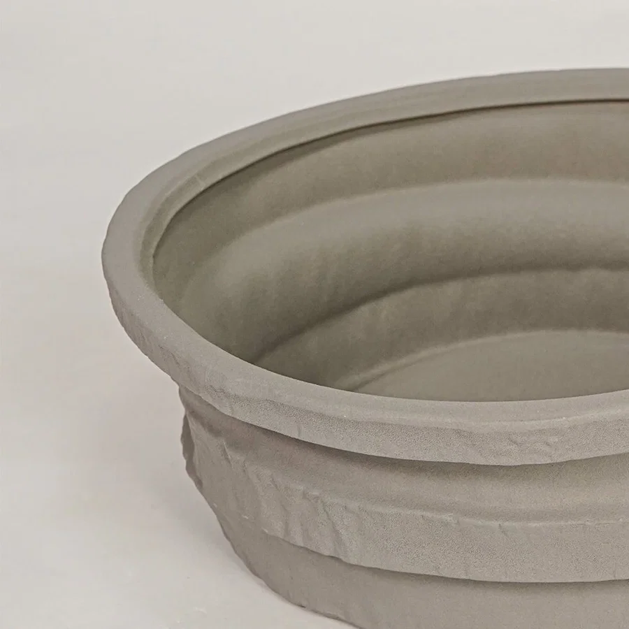 Closeup of grey ceramic decorative bowl with layered textured finish for elegant tabletop decor styling ideas.